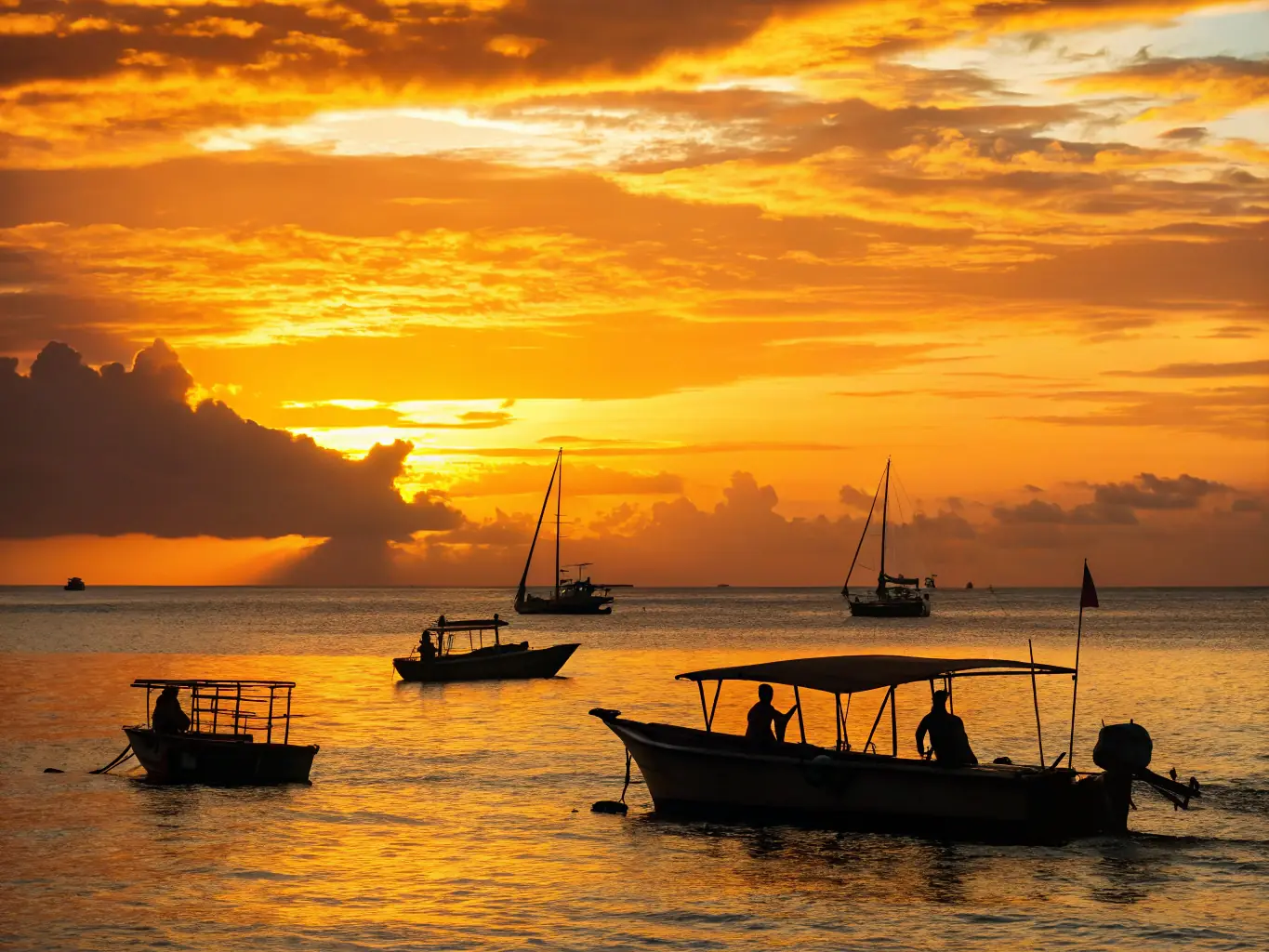A vibrant image of a group sailing on calm waters at sunset, with smiling participants enjoying the activity, representing the nautical activities offered by CLUB NAUTIQUE DE PORT DIEU.